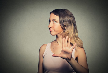 annoyed angry woman with bad attitude giving talk to hand gesture