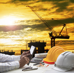 hand of architect working on computer tablet  with construction