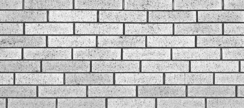 White brick stone wall seamless background and texture