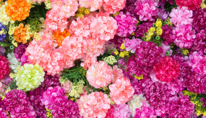 Fototapeta premium Colourful artificial flower made from plastic and fabric