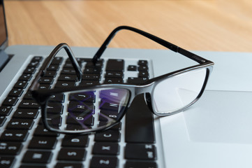Vision through lens of spectacles to a computer keyboard