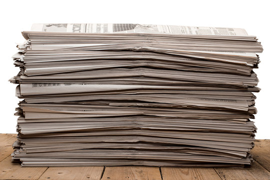 A stack of old newspapers on white background