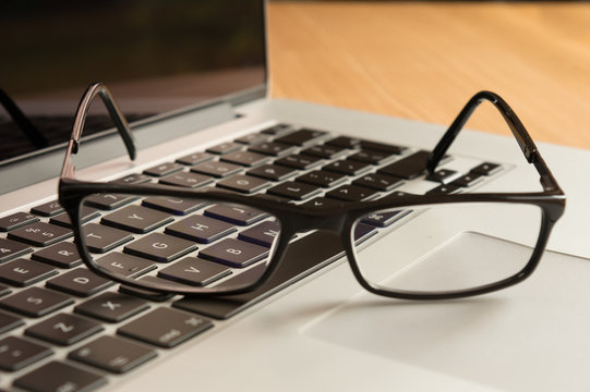 Laptop keyboard through the lens of spectacles