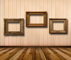 Interior of room with striped wallpaper and gold wooden frames