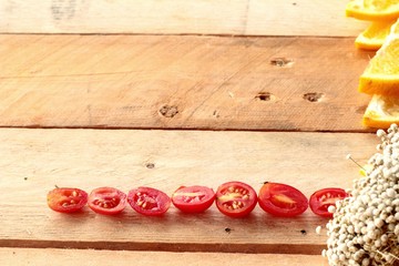 Oranges fruits and tomatoes sliced on wood background