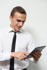 Businessman holds up a electronic tablet