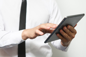 Businessman holds up a electronic tablet