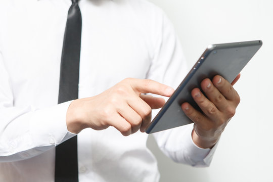 Businessman holds up a electronic tablet