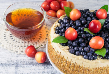 Celebratory cake with blueberries, sweet cherry, mint leaves and