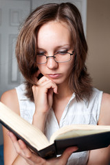 Student girl reading a book inddors
