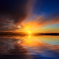 Fototapeta na wymiar sunset scene over lake water surface