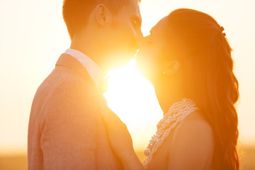 Wedding couple kissing in the sunset