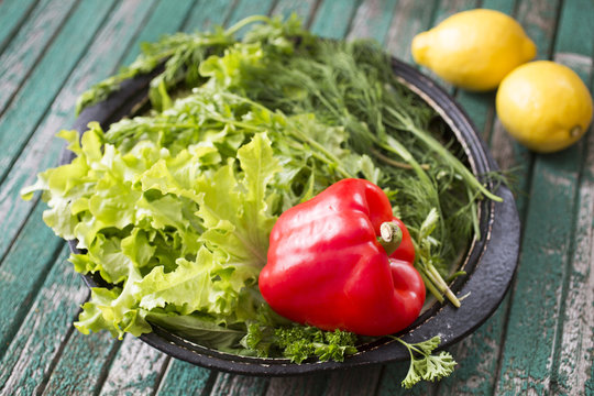 Peppeк and green-stuff on the old table