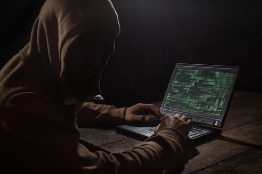Silhouette of a hacker with laptop