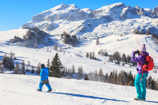 Mother child photographs on the slopes at the ski resort of Selv