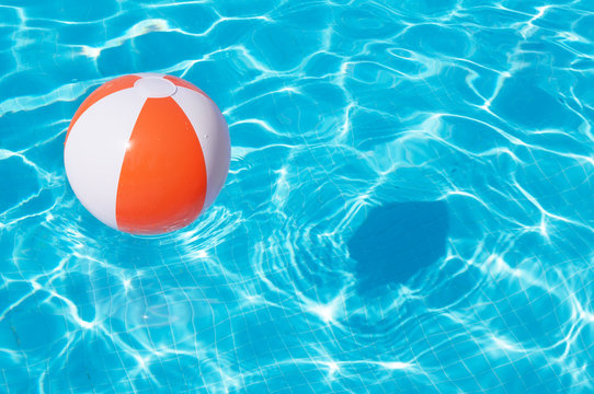 Colorful beach ball floating in a pool