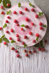 cheese cake with fresh raspberries and mint close-up. vertical top view