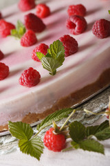 Raspberry cheesecake with mint macro on the table. vertical