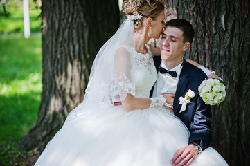 exciting elegant wedding couple walking at park in love