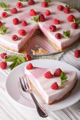 sweet cheesecake with raspberries and mint close-up. vertical