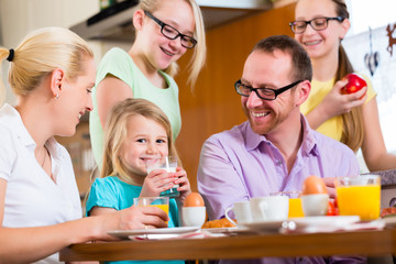 Family at home having breakfast in kitchen