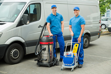 Two Cleaners Standing With Cleaning Equipments