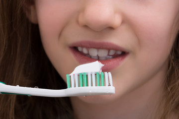 Close-up Of Girl Brushing Teeth