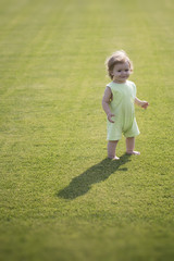 Baby boy on green grass