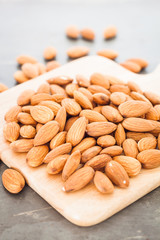 Almond nuts on wooden plate