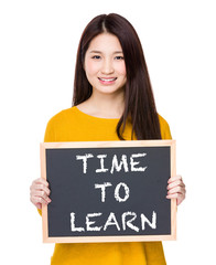 Woman hold blackboard showing the phrases of time to learn