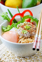 Chinese noodles with minced pork and egg in bowl