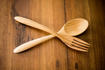 wood spoons and wood fork on wood backgrounds