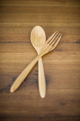wood spoons and wood fork on wood backgrounds