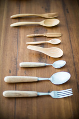 wood spoons and wood fork on wood backgrounds