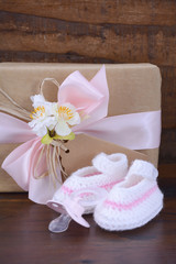Baby Shower Gift with Booties on Dark Wood