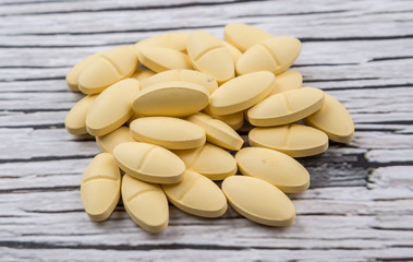 Medicinal pills over rustic wooden background