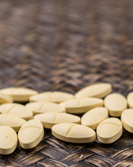 Medicinal pills over wicker background