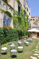 Chairs and tables in the green garden restaurant