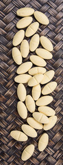 Medicinal pills over wicker background