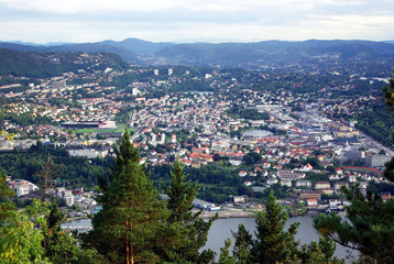 Norway. City of Bergen in the evening at sunset. Shooting a bird's eye view. View of the houses, streets, washing the fjord surrounding mountains. Picture 2500 * 1674.

