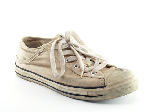 single beige canvas shoes isolated on white, old extreme sport sneakers