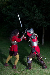 Side View of Two Knights in Battle in Dark Forest