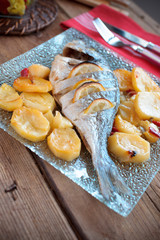 bream baked with lemon roasted potatoes and vegetables in glass
