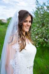 portrait of beautiful bride in blooming garden