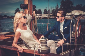 Stylish wealthy couple on a luxury yacht