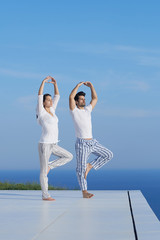 young couple practicing yoga