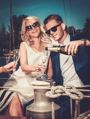 Foto op Plexiglas Stylish wealthy couple on a luxury yacht © Nejron Photo