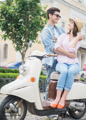 Fototapeta na wymiar Young couple on scooter
