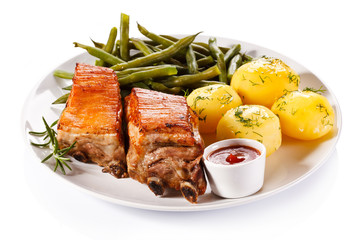 Grilled ribs, boiled potatoes and vegetables 