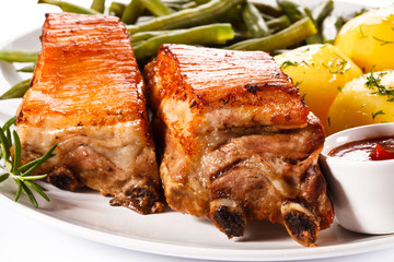 Grilled ribs, boiled potatoes and vegetables 
